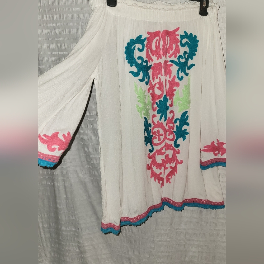 Gorgeous off the shoulder top with applique on front,sleeves and bottom.  Size L